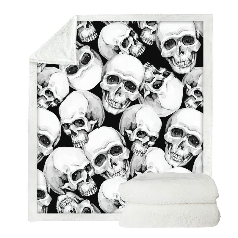 Gothic plush Sherpa blanket featuring a striking skull design on a black background, perfect for cozying up in style.