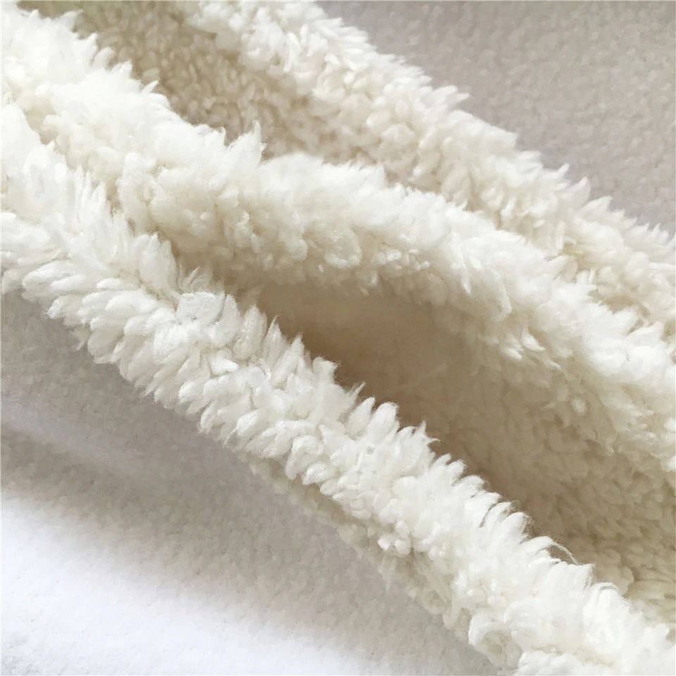 Close-up of soft, plush Sherpa fabric, perfect for a cozy gothic blanket.