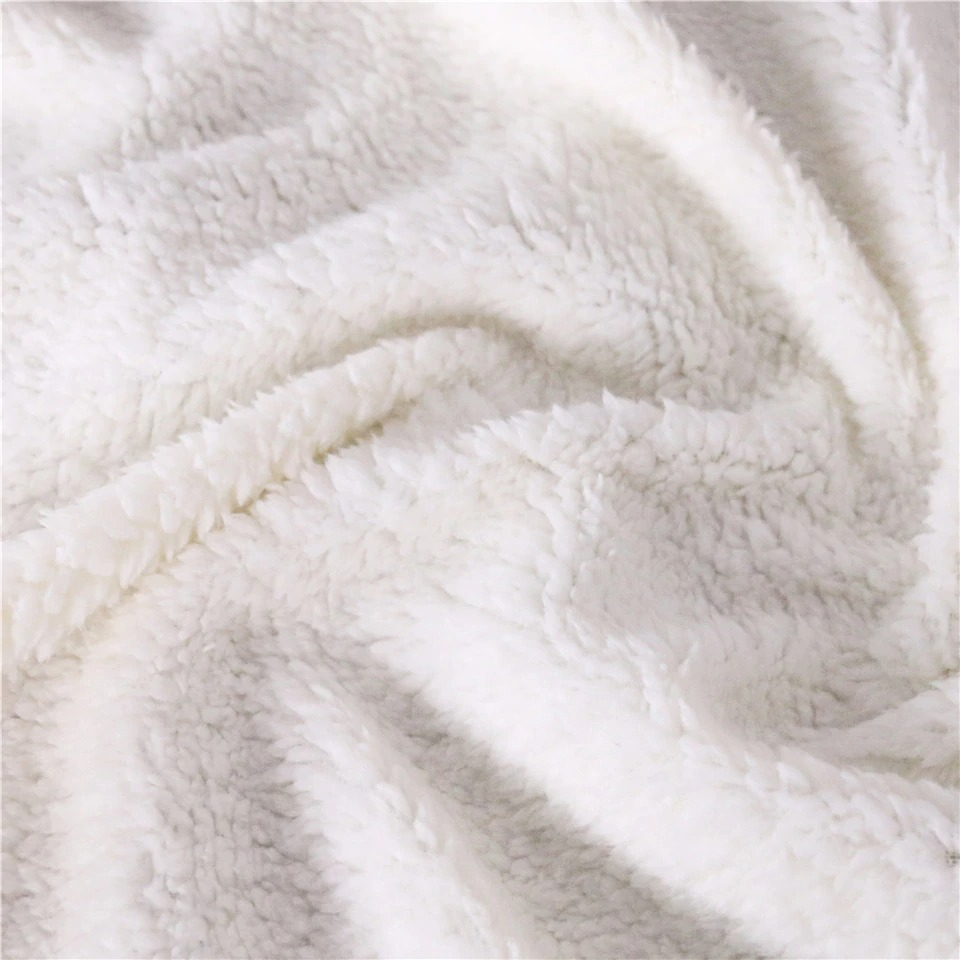 Close-up of soft white Sherpa fabric, perfect for cozy blankets and plush home decor.