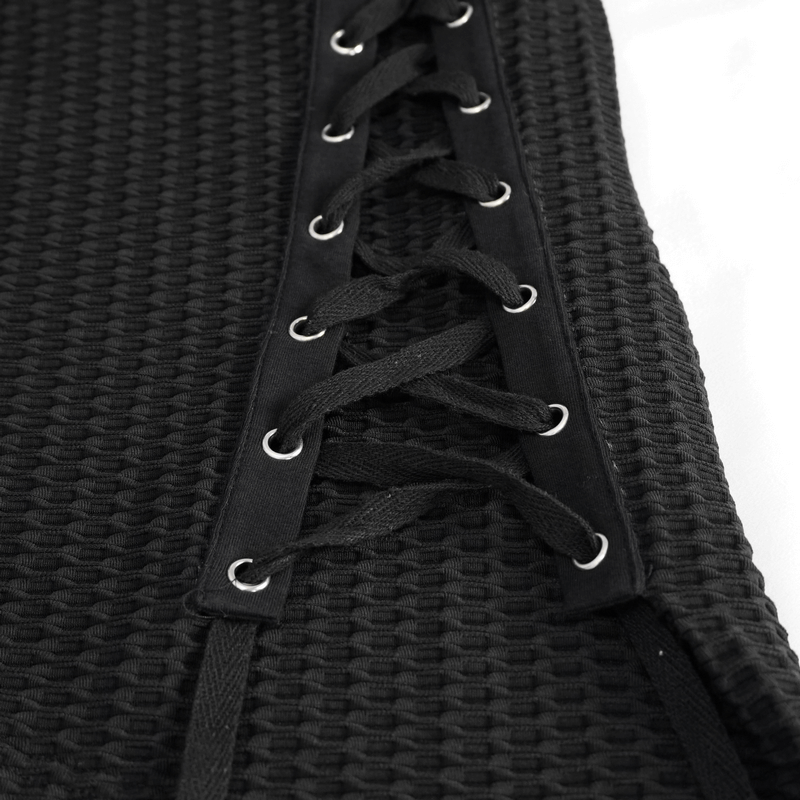 Close-up of gothic punk lace-up detail on a black sweatshirt, showcasing stylish textured fabric.