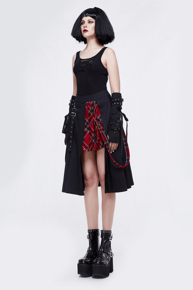 Gothic punk style woman in black asymmetrical skirt with plaid accents, showcasing trendy punk fashion.