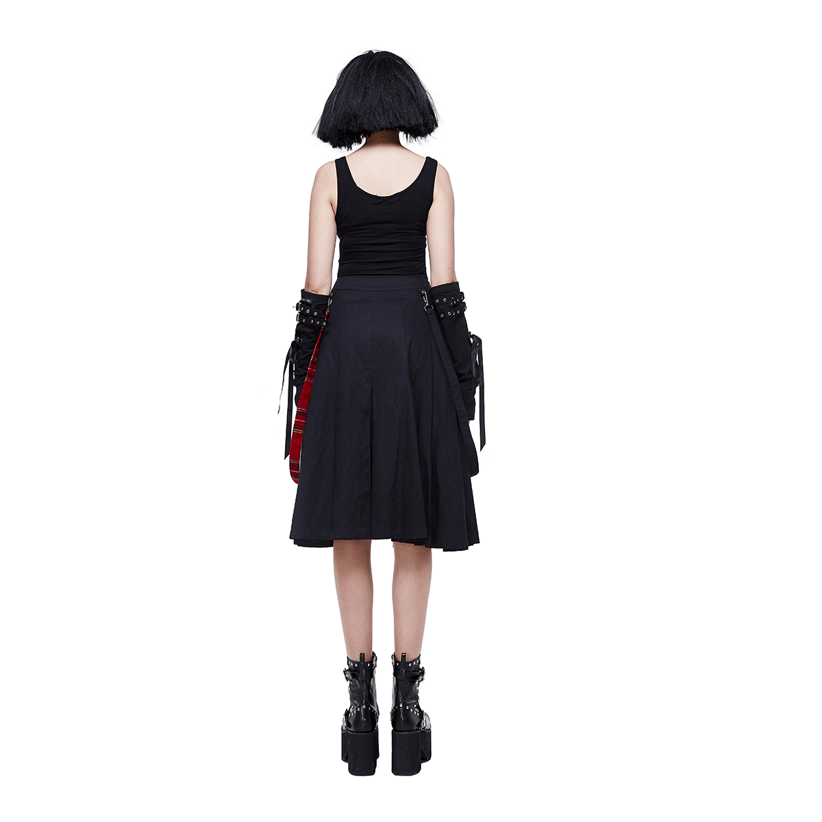 Back view of a woman in a Gothic punk black asymmetrical skirt paired with edgy platform boots.