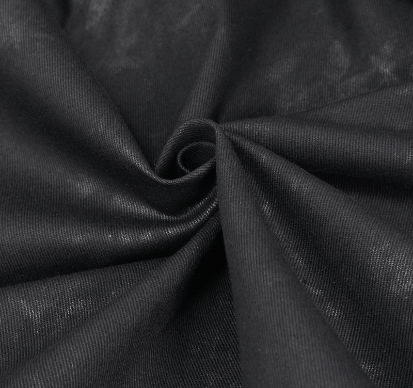 Close-up of premium black fabric showcasing texture and shine for women's punk fashion shorts.