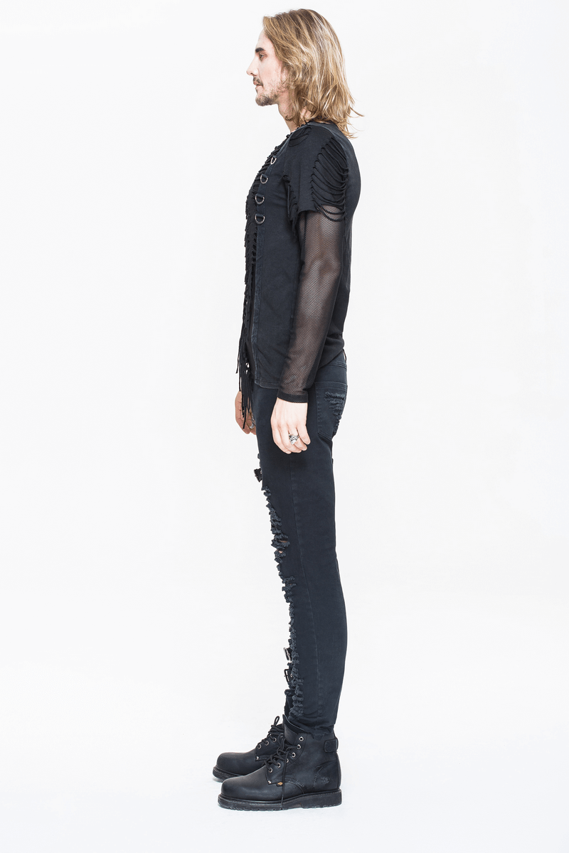 Side view of a man in a gothic punk long sleeve black top with mesh sleeves and ripped detailing, paired with black skinny jeans.
