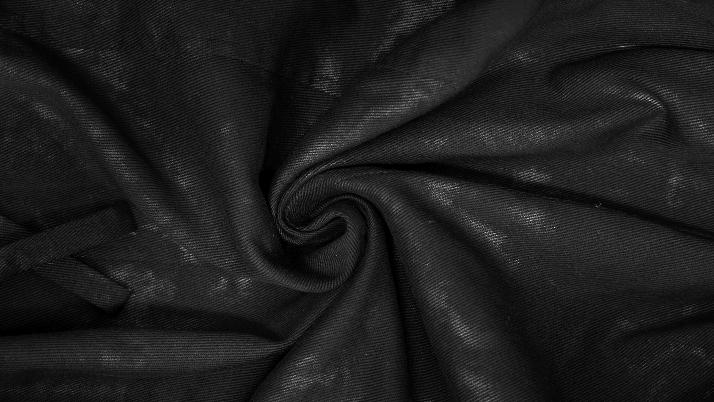 Textured black fabric swirl, perfect for gothic punk trench coats and stylish apparel.