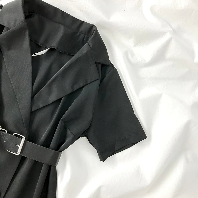 Black short sleeve blazer dress with belt on a white fabric background, showcasing gothic punk fashion style.