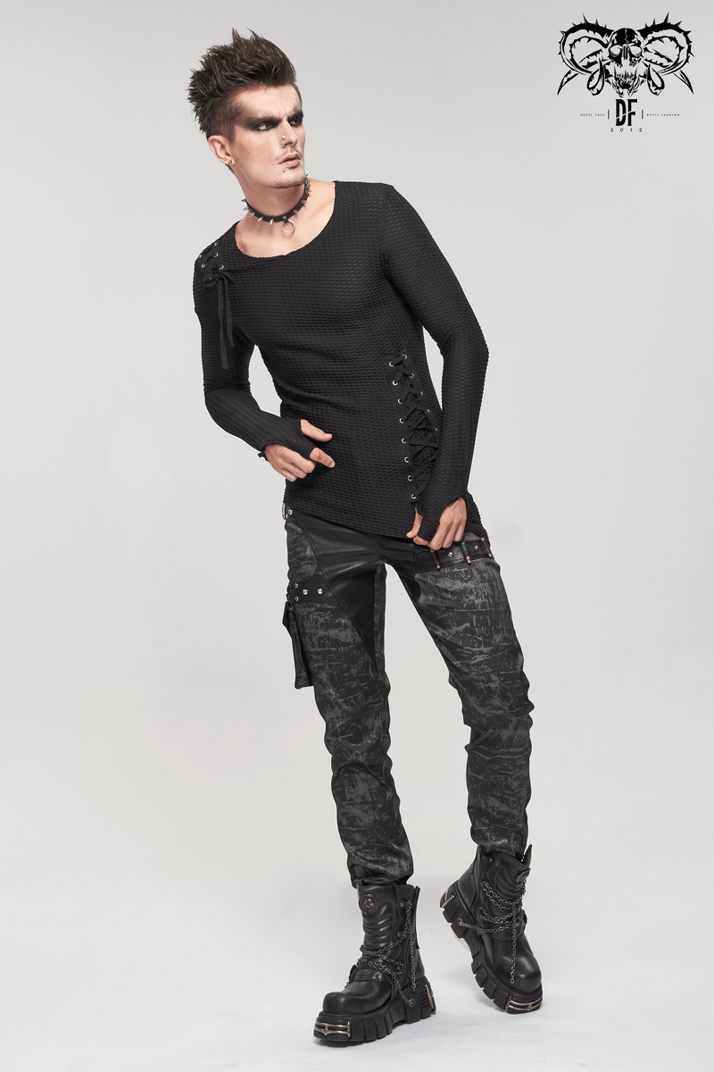 Fashionable model in gothic punk style, wearing black long trousers and a fitted top with stylish details.