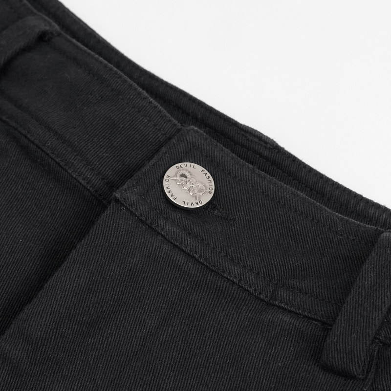 Close-up of the button and waistband of men's gothic ripped black pants with punk style.