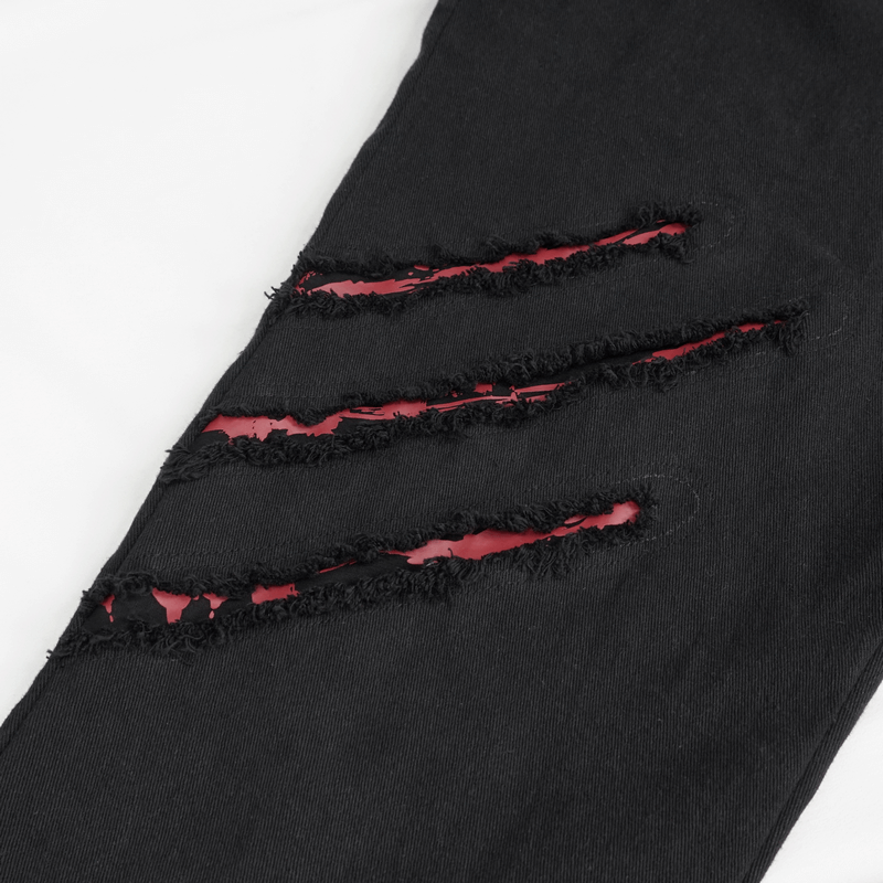 Gothic ripped pattern on men's black pants, showcasing punk style and edgy fashion details.
