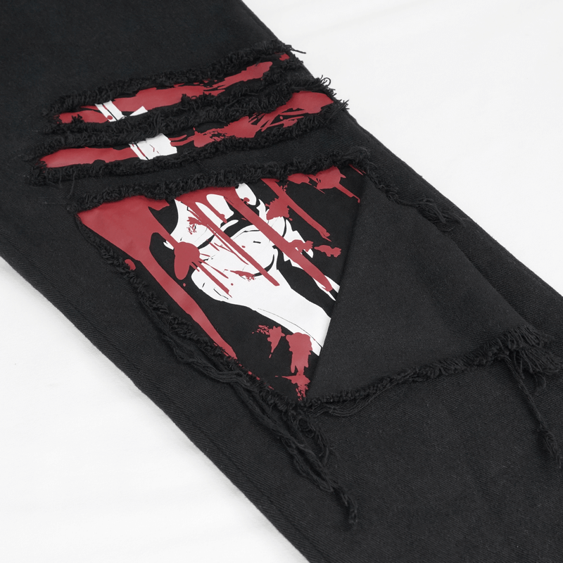 Close-up of gothic ripped pattern on black men's pants showcasing punk style design with red graphic detail.