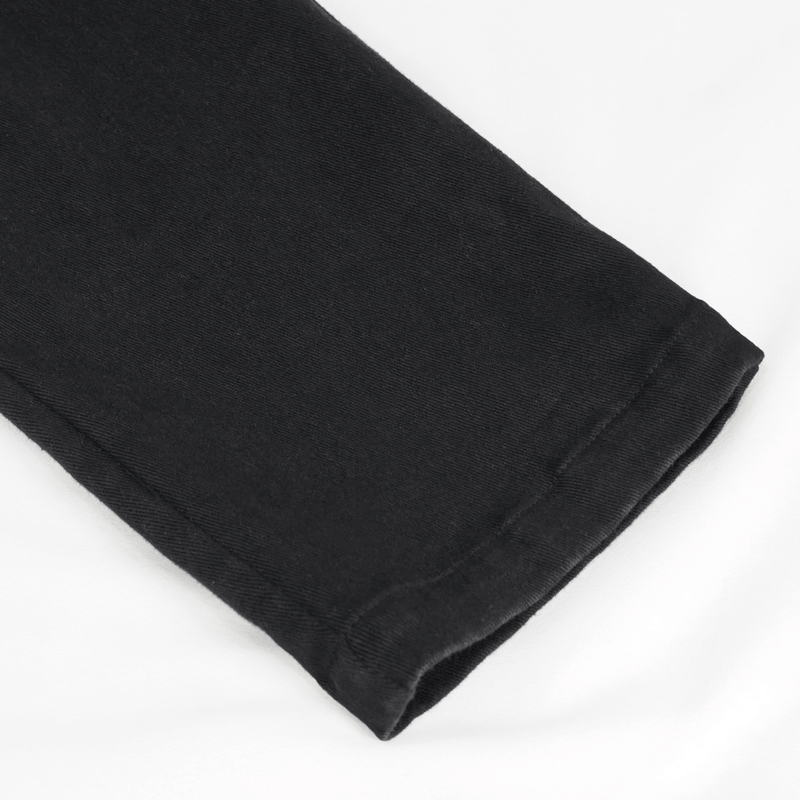 Close-up of the hem of trendy black ripped pattern pants for men, showcasing punk fashion style and modern cut.