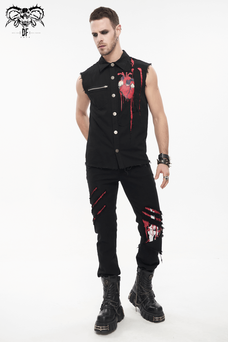 Stylish man in black sleeveless shirt and ripped black pants, showcasing a punk rock aesthetic with edgy details.