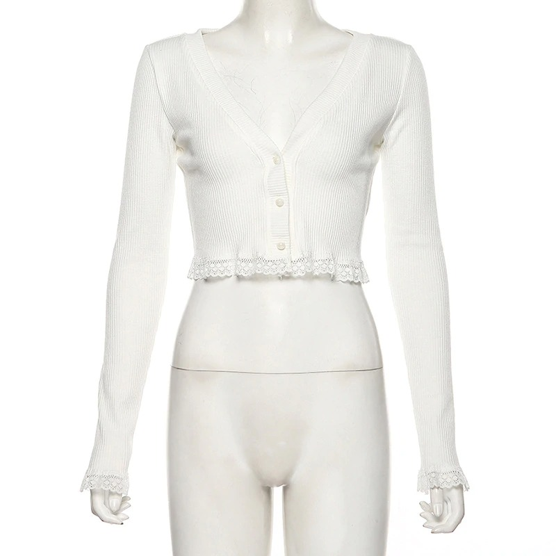 White long sleeve crop top with lace trim and button front, perfect for layering in a trendy autumn outfit.