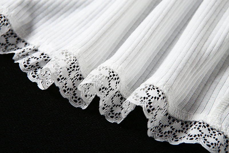 Close-up of white lace trim on ribbed fabric, perfect for a gothic-style crop top or elegant outfit.