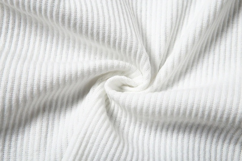 Close-up of soft white ribbed fabric, showcasing the texture and pattern for fashion design inspiration.