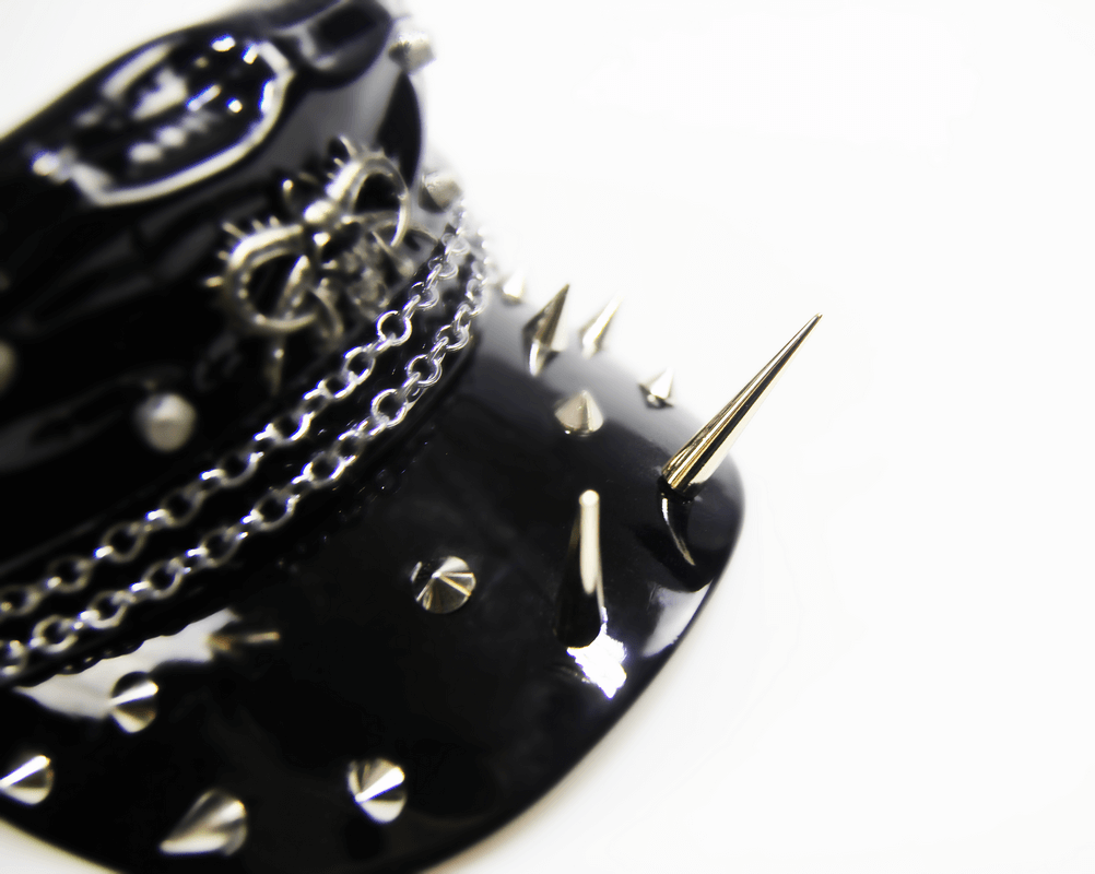 Close-up of a gothic shiny vinyl military cap featuring spikes and chains, perfect for stylish women.