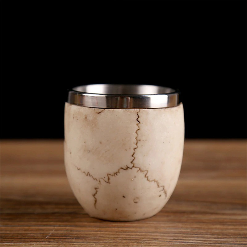 Unique stainless steel and stone shot glass with a rustic finish, perfect for Gothic drinkware collections.