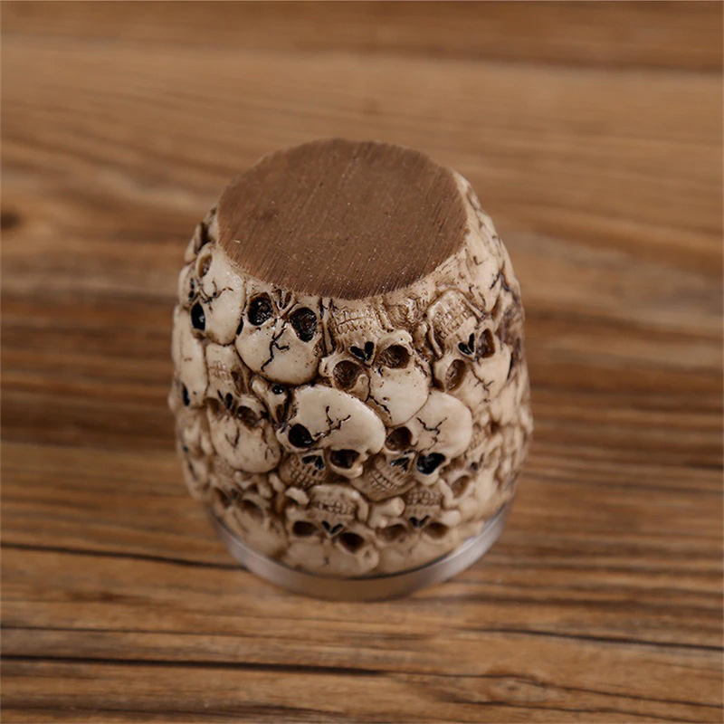 Gothic skull shot glass with intricate detailing against a wooden background, perfect for drinkware collection.
