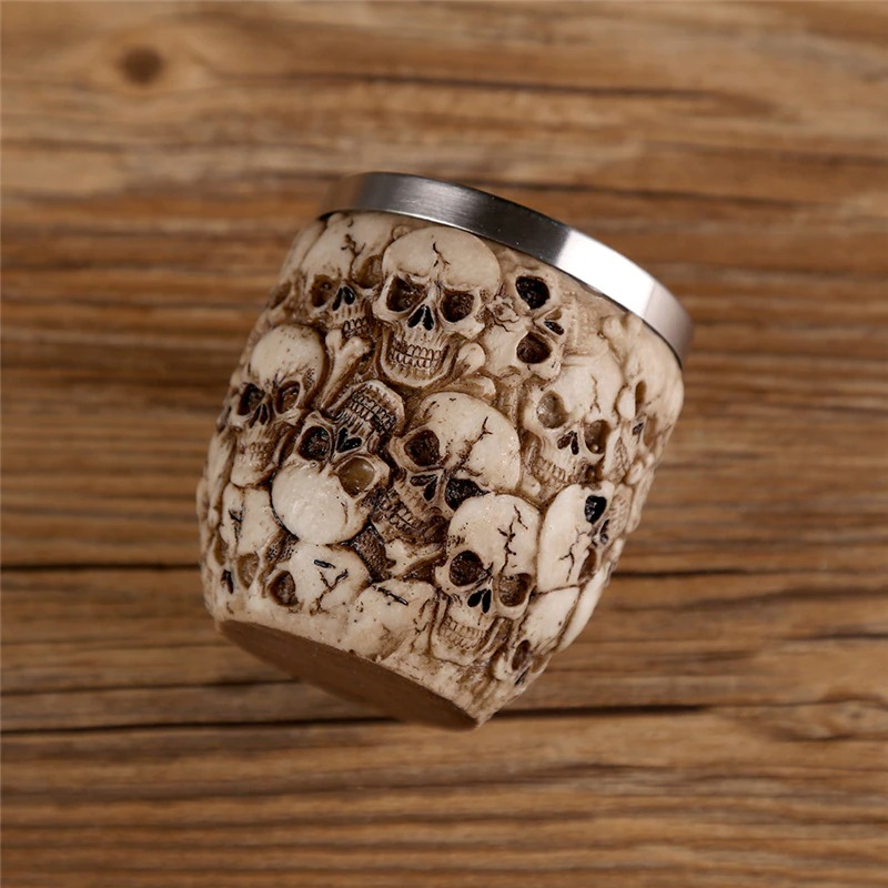 Gothic stainless steel skull shot glass with intricate skull design, perfect for themed drinkware or decor.