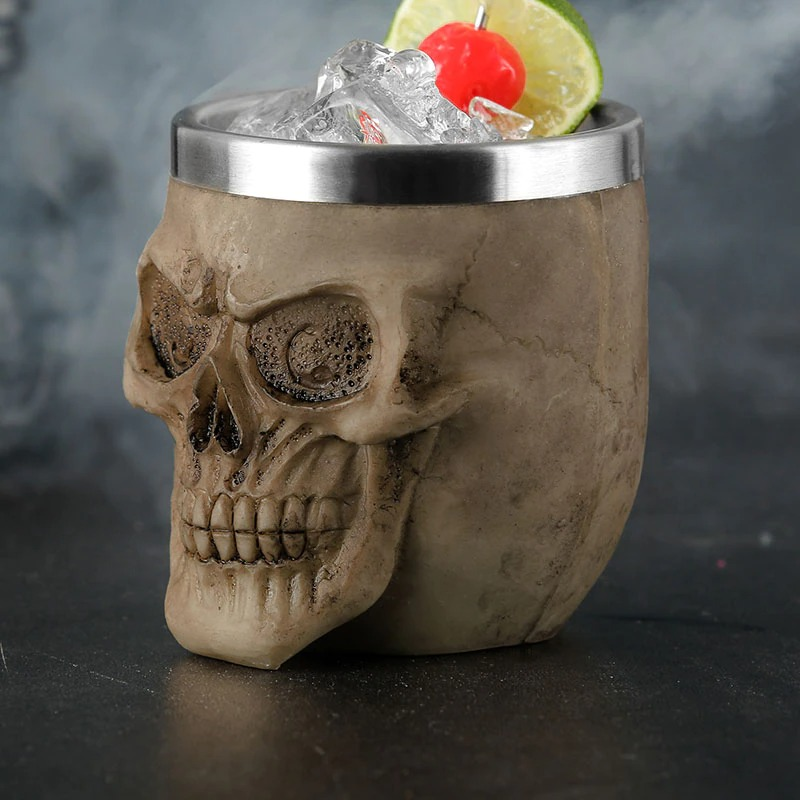 Gothic skull shot glass with ice and garnished lime and cherry, perfect for alternative drinkware collections.