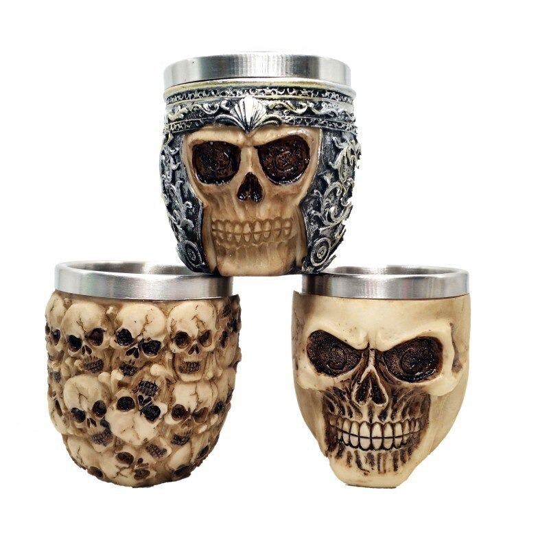 Gothic stainless steel skull shot glasses, featuring intricate designs, perfect for unique drinkware or gothic decor.
