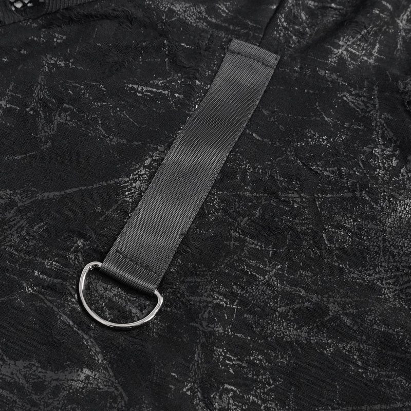 Close-up of black fabric with decorative ring and strap from a gothic punk hooded tank top.
