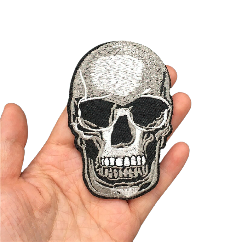 Gothic skull patch held in hand, perfect for jackets and unisex rock style outfits.