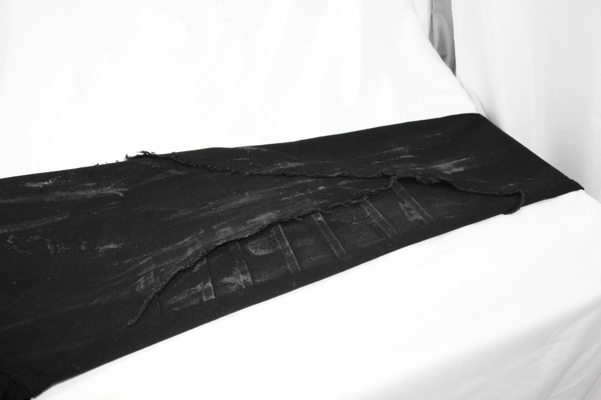 Gothic slim fit black pants with distinctive lace-up design and stylish distressed details.