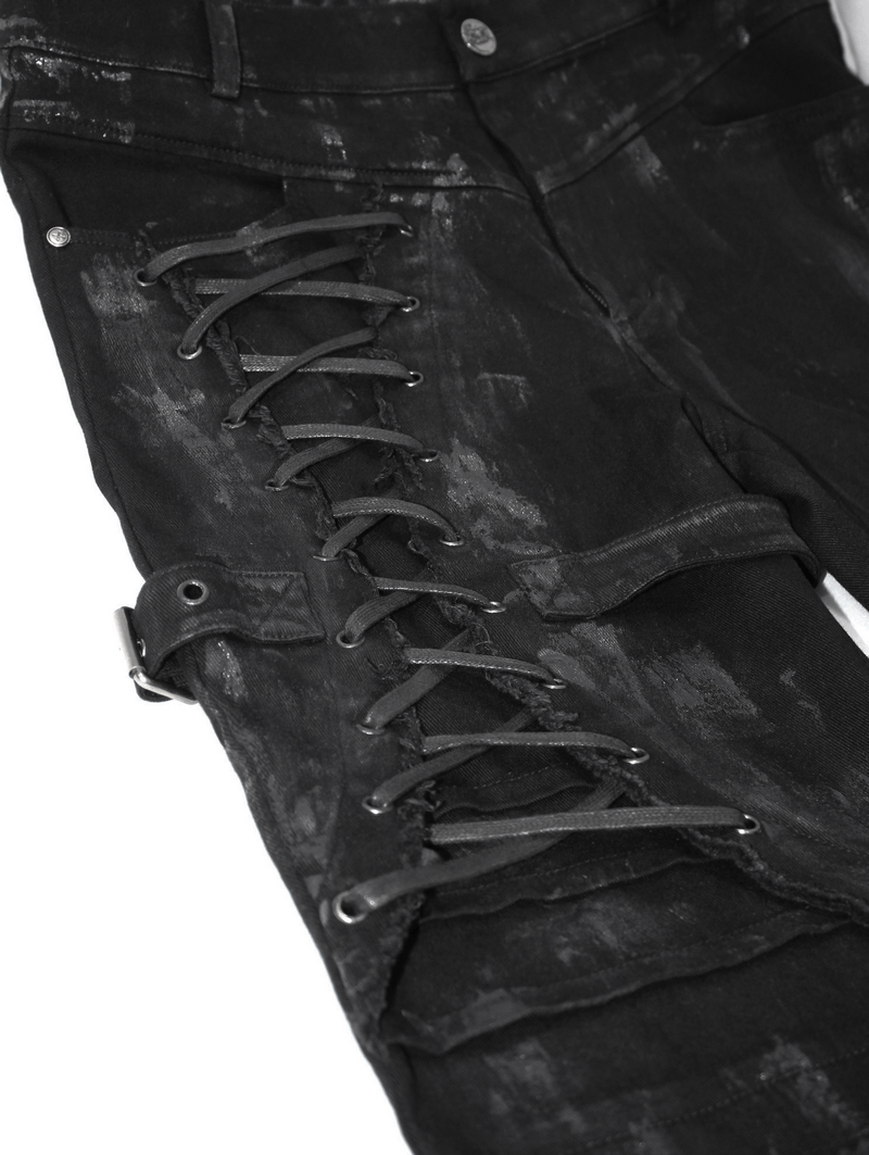 Close-up of Gothic slim fit black pants featuring lace-up detail on the right leg and stylish belt buckle.