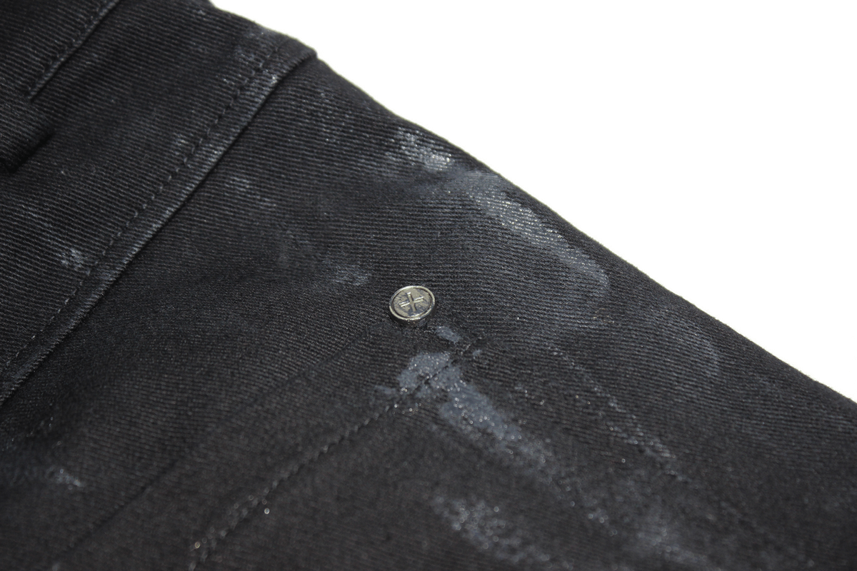 Close-up of Gothic slim fit black pants showcasing decorative belt buckle and unique fabric details.