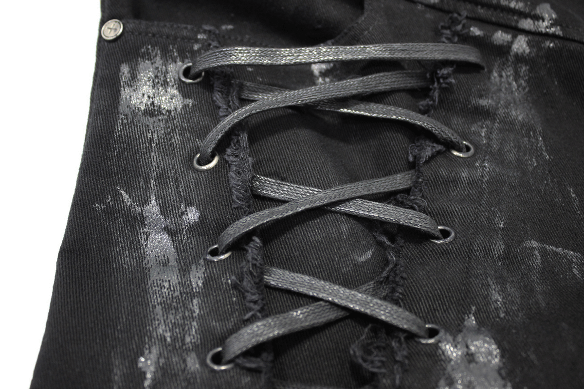 Close-up of Gothic slim fit pants featuring lace-up detail on the right leg, showcasing black stylish fabric.