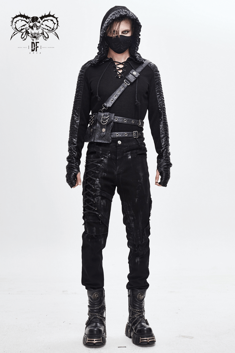 Gothic men in black outfit with lace-up pants and hoodie, showcasing edgy stylish fashion.