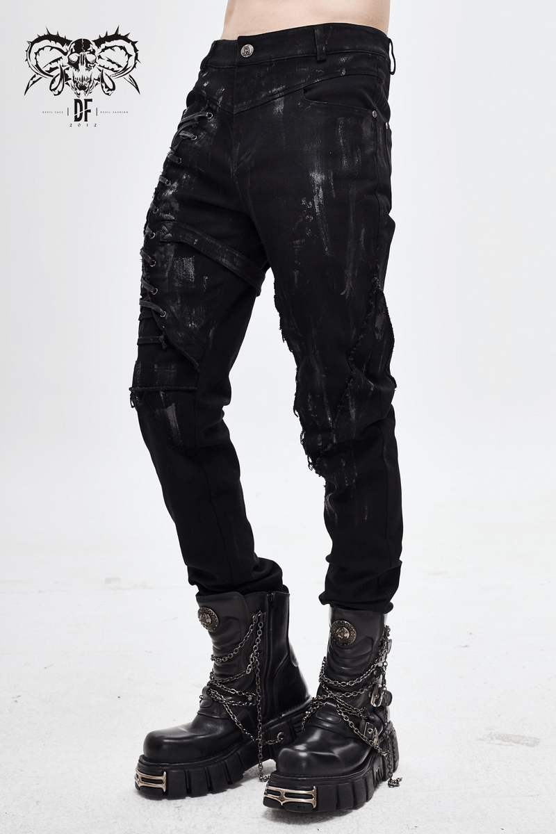 Gothic slim fit black pants with distressed details and lace-up on leg, paired with stylish combat boots.