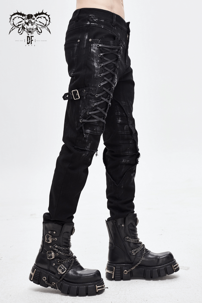 Gothic slim fit black pants with lace-up details and belt buckle, paired with chunky black boots.