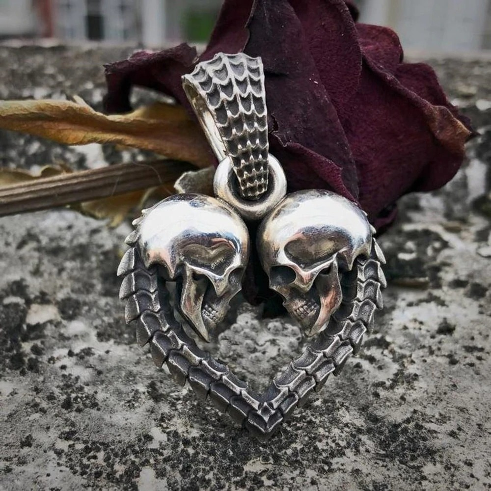 Gothic stainless steel double skull heart necklace pendant with intricate details and a striking design.