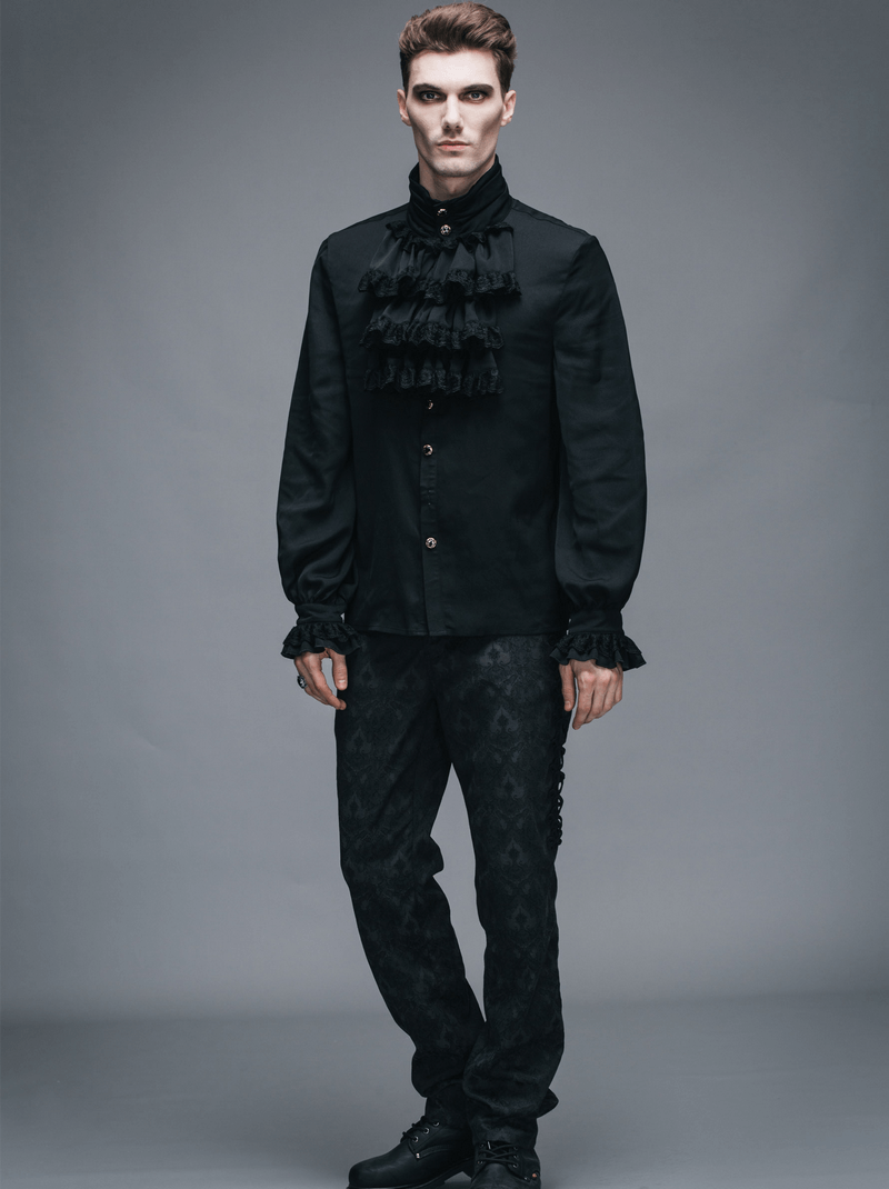 Gothic steampunk male wearing a vintage black flounce tie shirt with long sleeves and ruffles, showcasing elegant style.