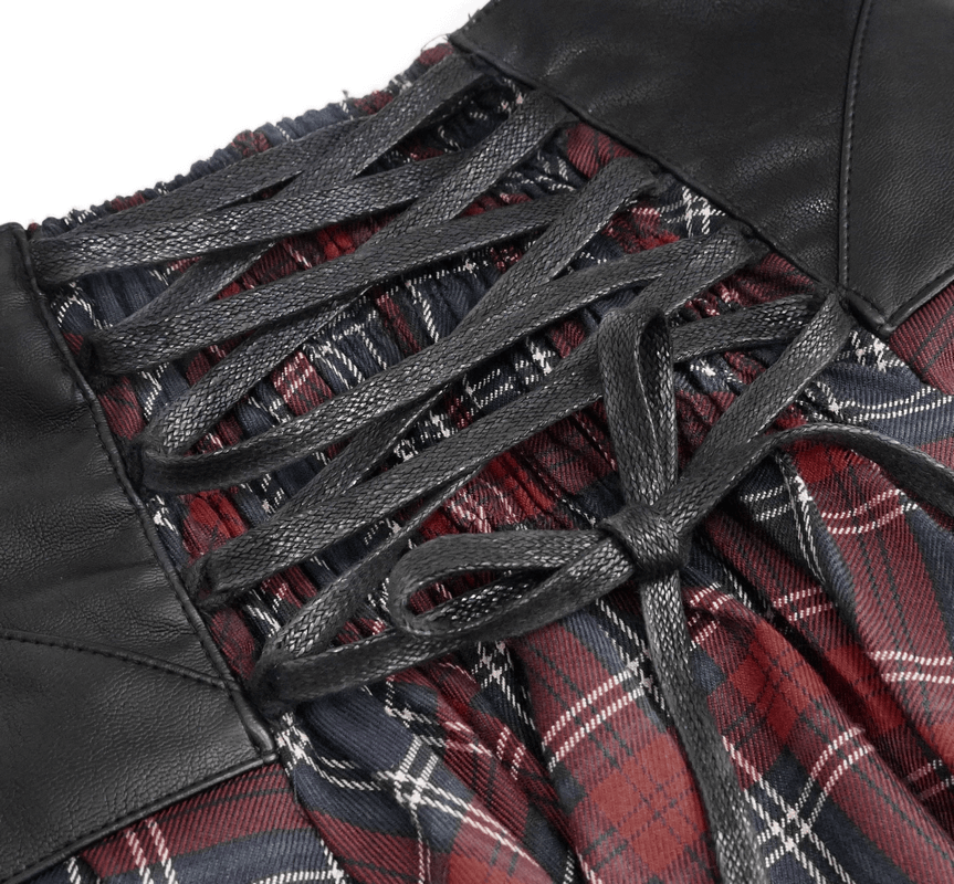 Close-up of the gothic strappy plaid skirt with lace-up detail and leather accents for a punk style look.