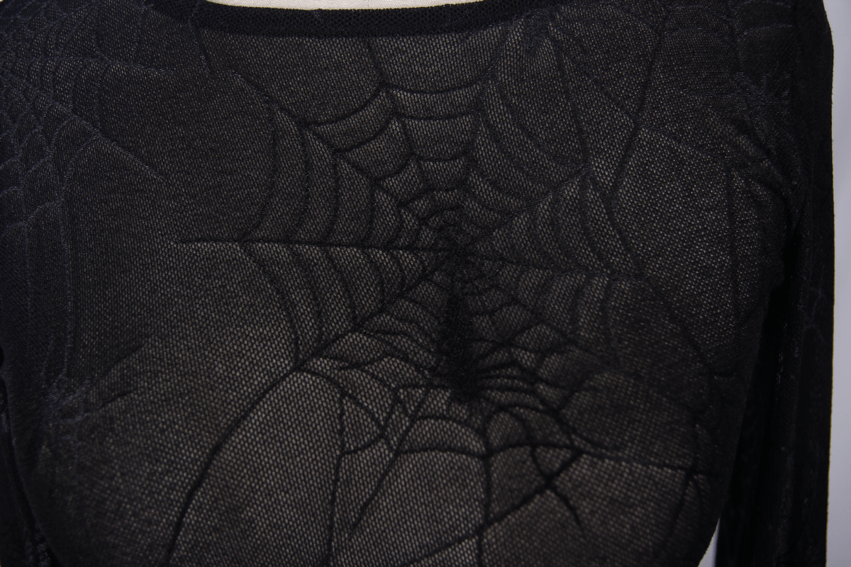 Close-up of a gothic black top featuring a spider web pattern, showcasing its trendy and transparent mesh design.