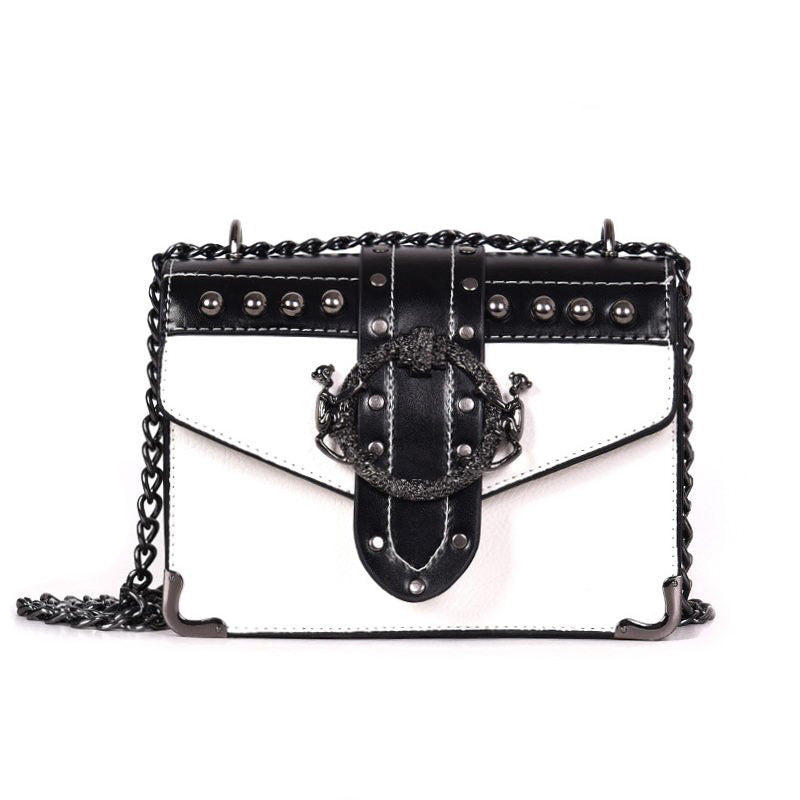 Gothic style women's square shoulder bag with rivet lock and chain strap, featuring black and white design and skull rivets.