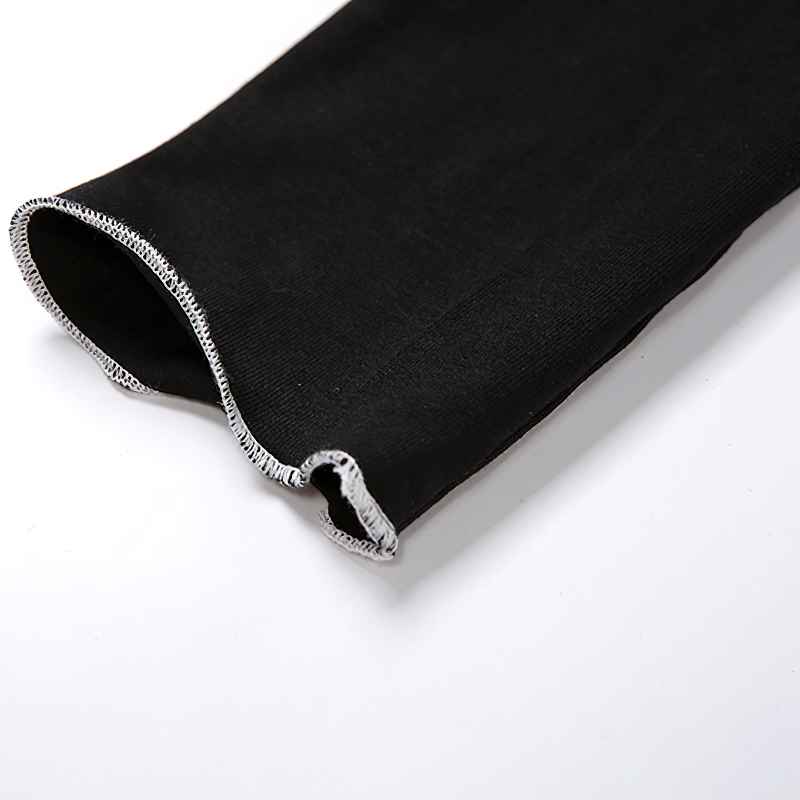 Close-up of detached sleeve from a gothic style crop top, featuring unique hollow-out design and soft black fabric.