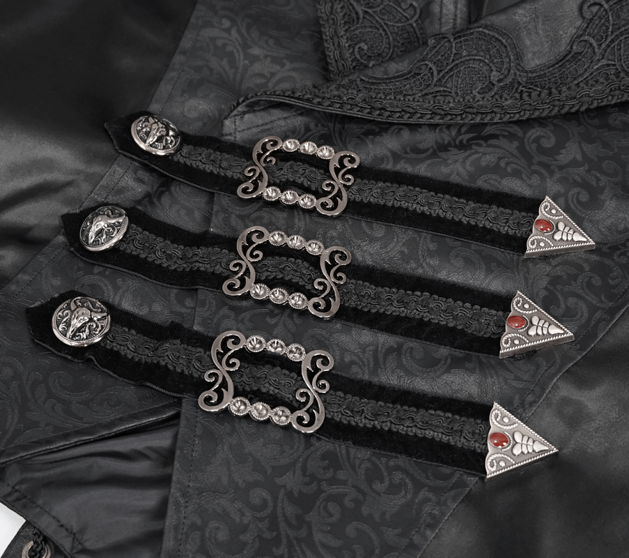 Detail of gothic style lace appliqué waistcoat with decorative buckles and intricate black fabric design.