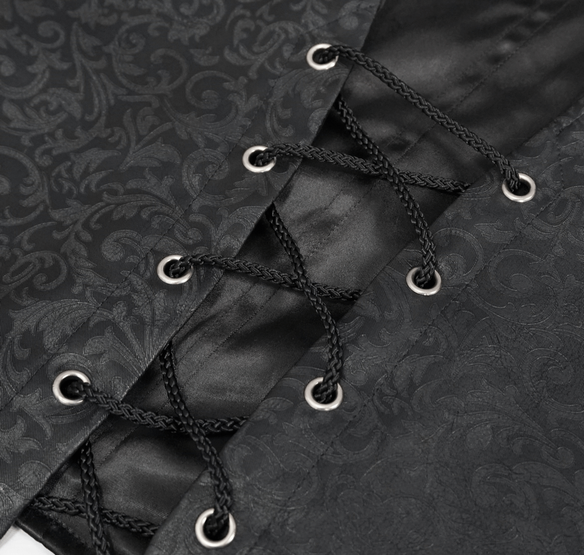 Close-up of gothic lace detailing and buckles on a black vintage waistcoat for men.