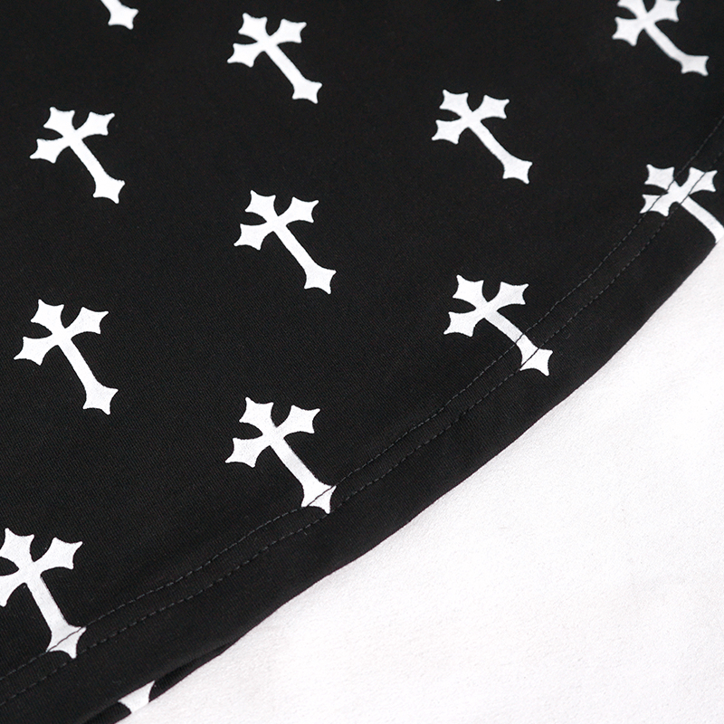 Close-up of a Gothic style blouse fabric featuring white crosses pattern on a black background for alternative fashion.