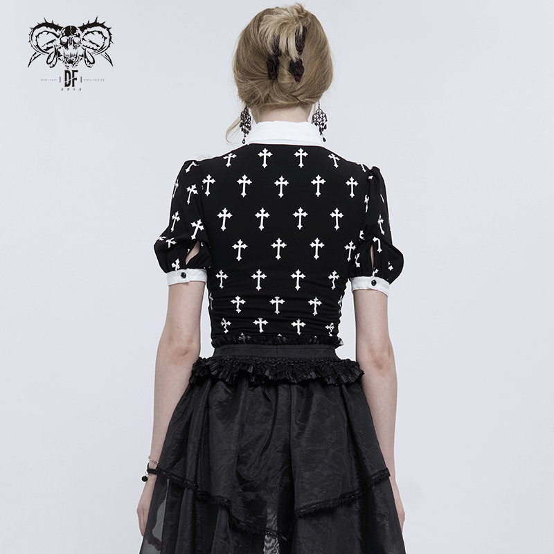 Gothic style women's blouse showcasing white crosses pattern, paired with a black skirt for alternative fashion flair.