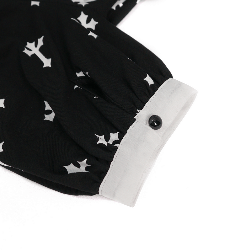 Gothic style short sleeve blouse detail featuring white crosses pattern and black button on the cuff.