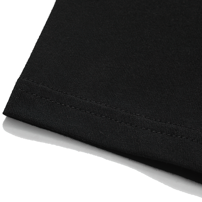 Close-up of the hemline on a black Gothic style unisex T-shirt, showcasing its soft fabric and stitching.