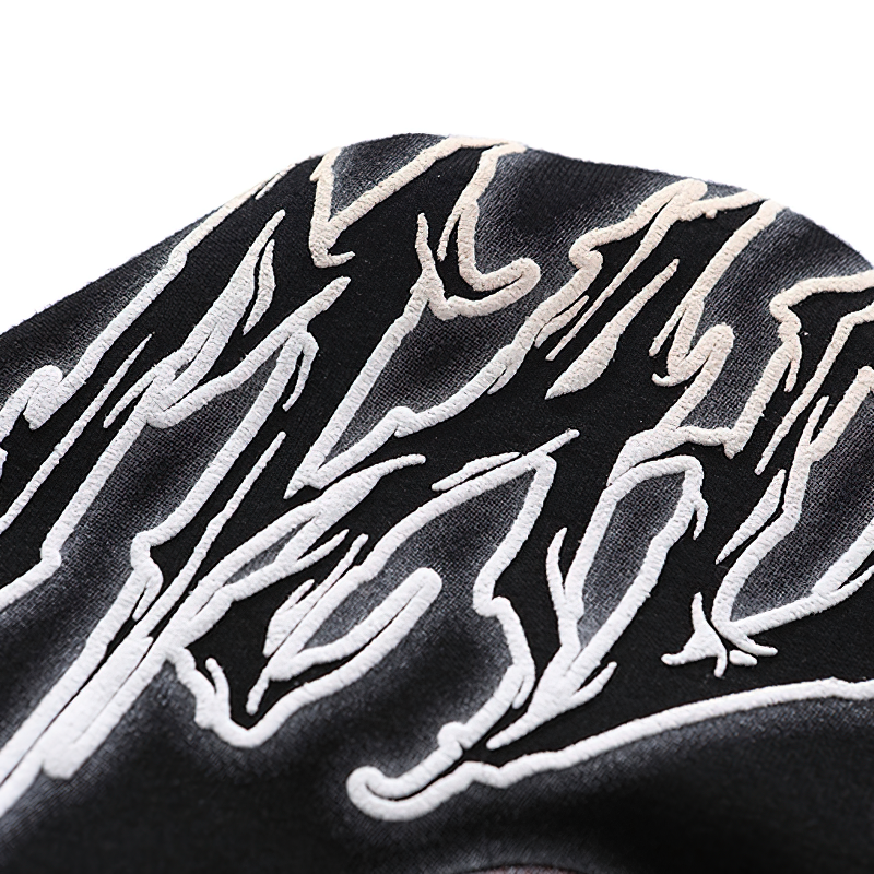 Close-up of gothic style t-shirt design, featuring bold white lettering on a black fabric for a casual unisex look.