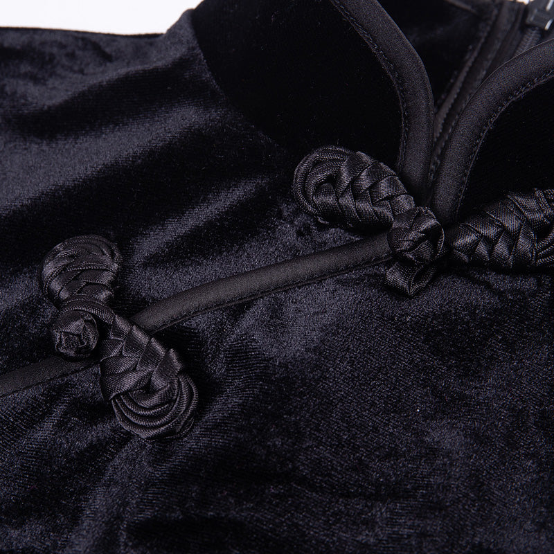 Close-up of black velvet fabric featuring intricate braided details and mandarin collar of a gothic style women's dress.