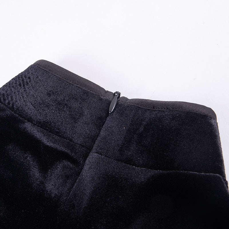 Close-up of a black velvet dress zipper detail showcasing luxurious texture and design.