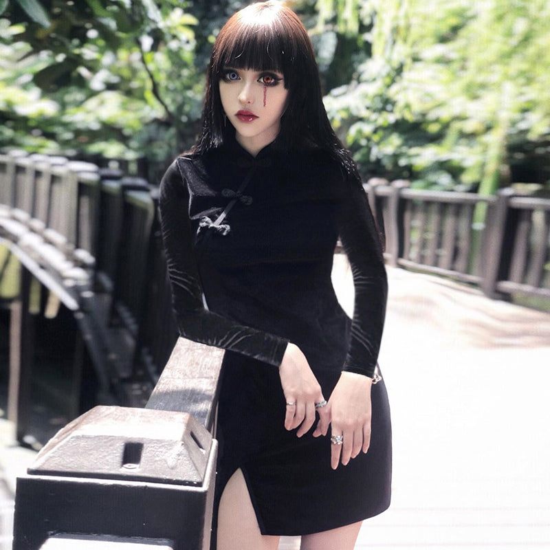 Gothic style velvet women dress with mandarin collar, perfect for alternative fashion lovers in a lush outdoor setting.